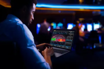 2G777 Casino Games — Enjoy nonstop entertainment A close-up shot of golden coins falling around a spinning roulette wheel, representing immersive casino action at 2G777.