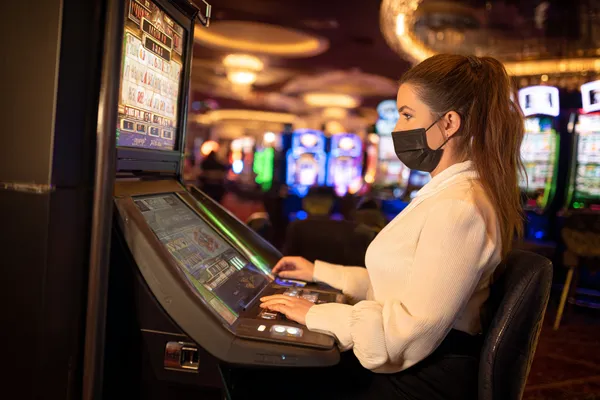 2G777 Mobile Casino — Play anytime, anywhere A player using their smartphone during a festive local event, representing 2G777’s fully mobile-friendly casino.